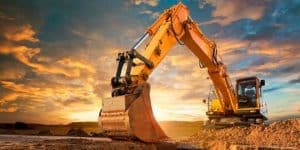 Worker operating an excavator during a demolition project.
