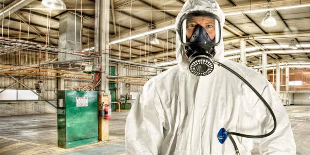 Asbestos removal contractor in protective gear ready to begin work