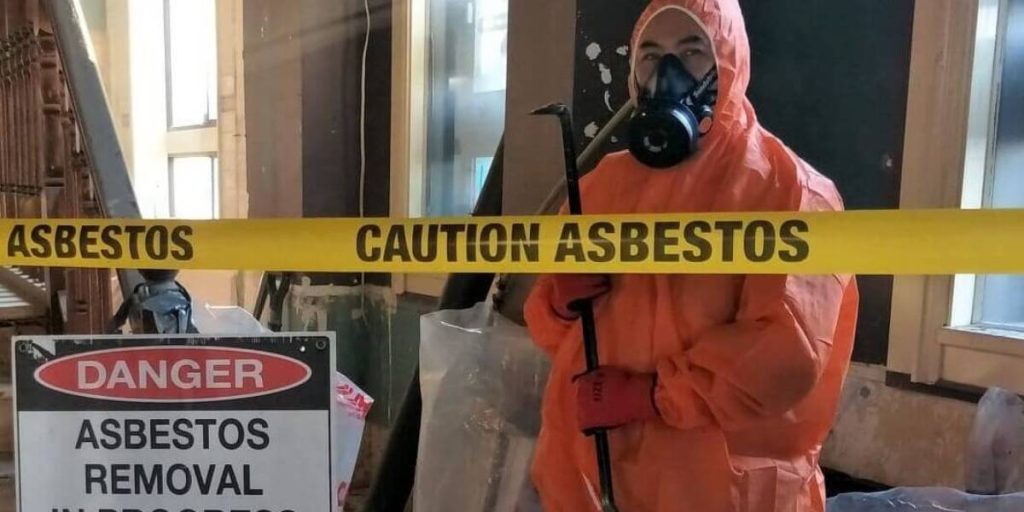 "Professional asbestos remover in protective gear safely disposing of asbestos materials, following health and safety regulations