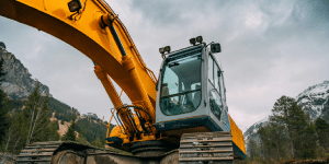 Active swimming pool removal in progress with an excavator demolishing the pool structure."
