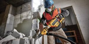 Worker using a jackhammer, a versatile demolition tools, in a construction site